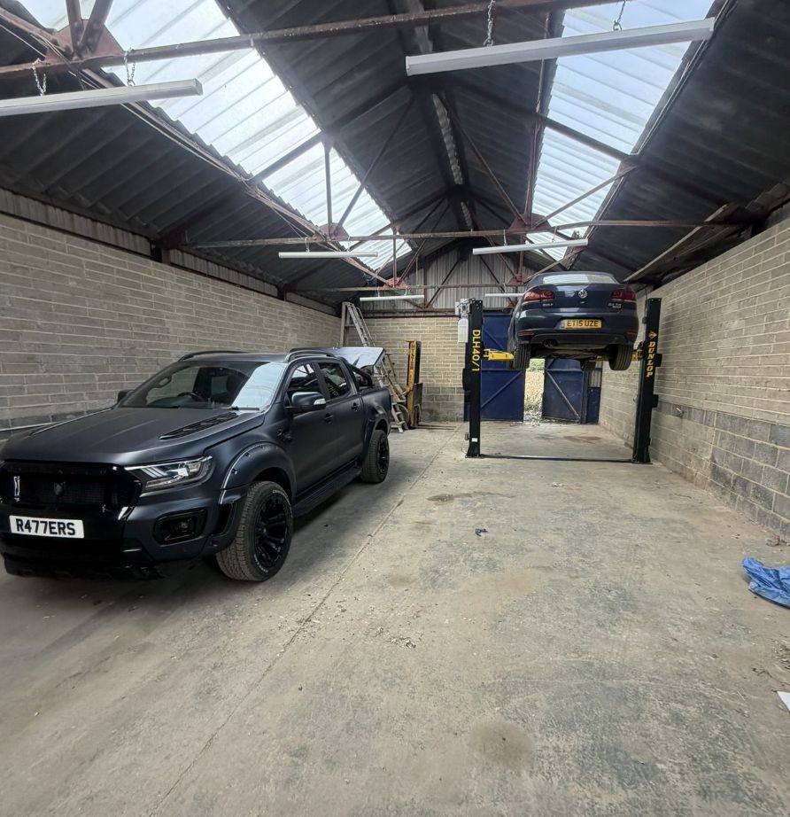 Inside the Elite Mechanics workshop in Kent with a vehicle on the two post ramp