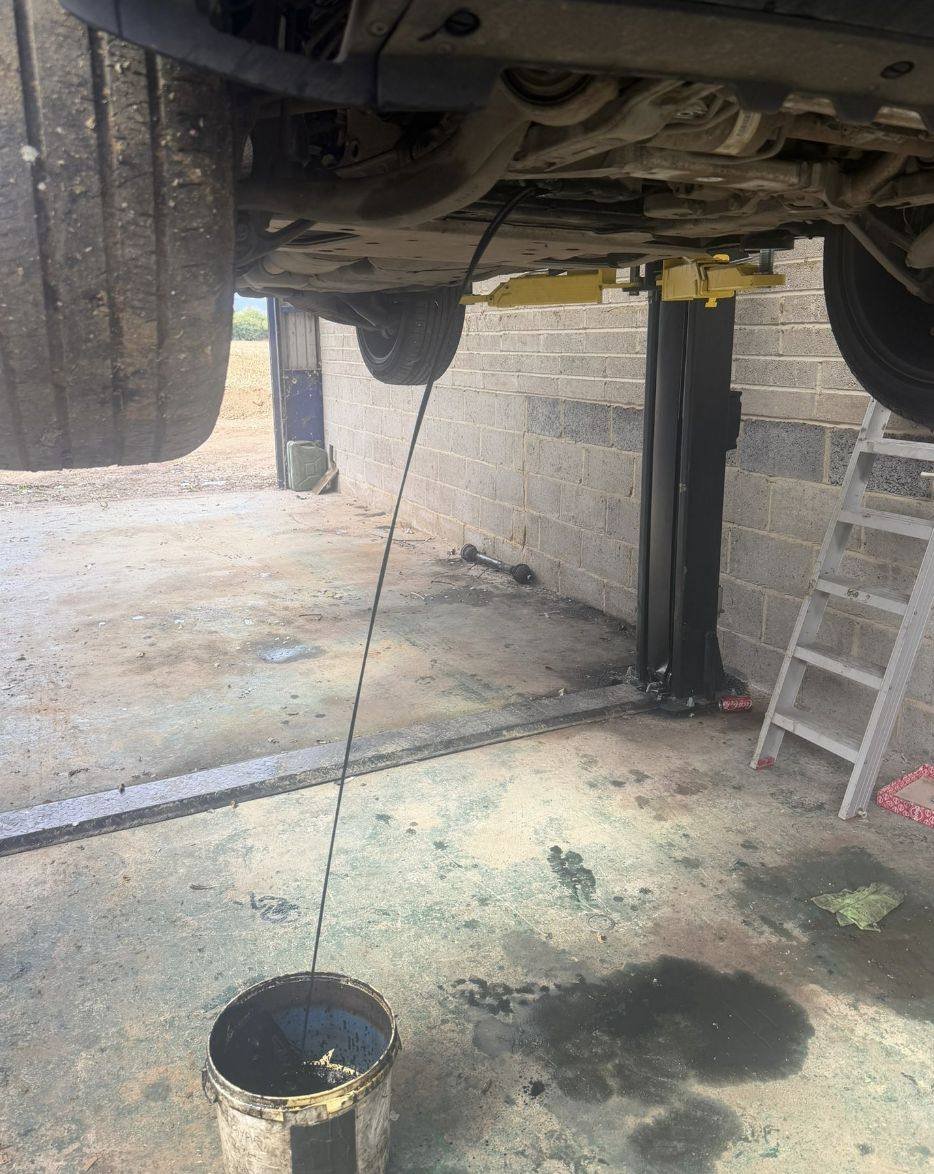Engine oil being drained during a car service in Kent